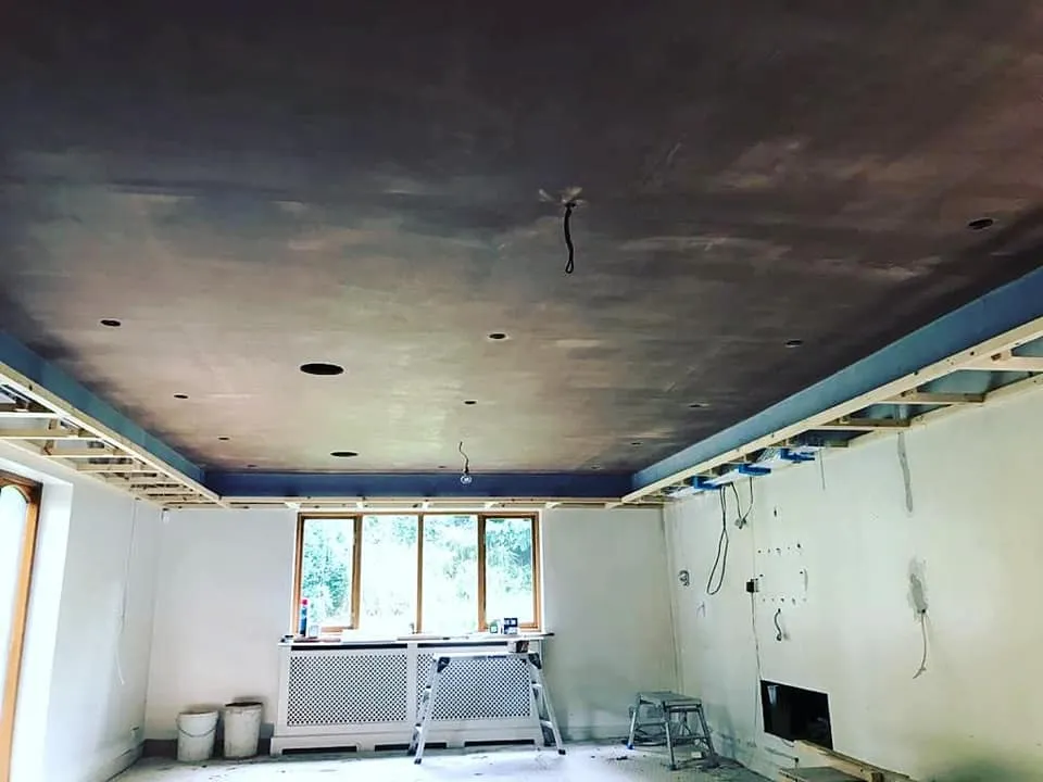 A room with a ceiling that has been painted blue.