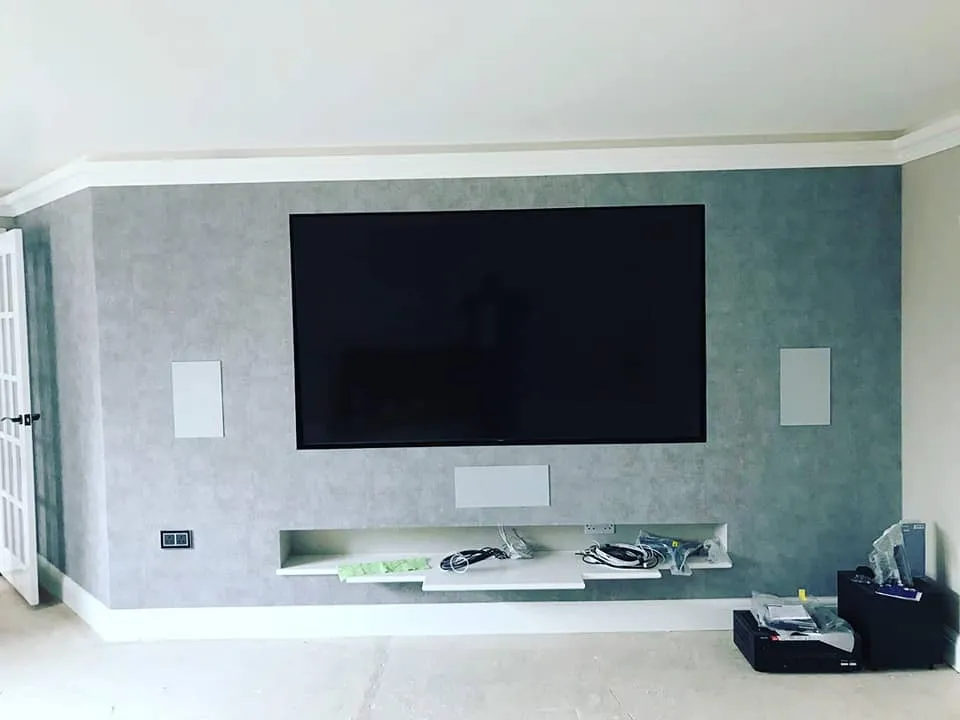 A flat screen tv mounted on a wall in a living room.