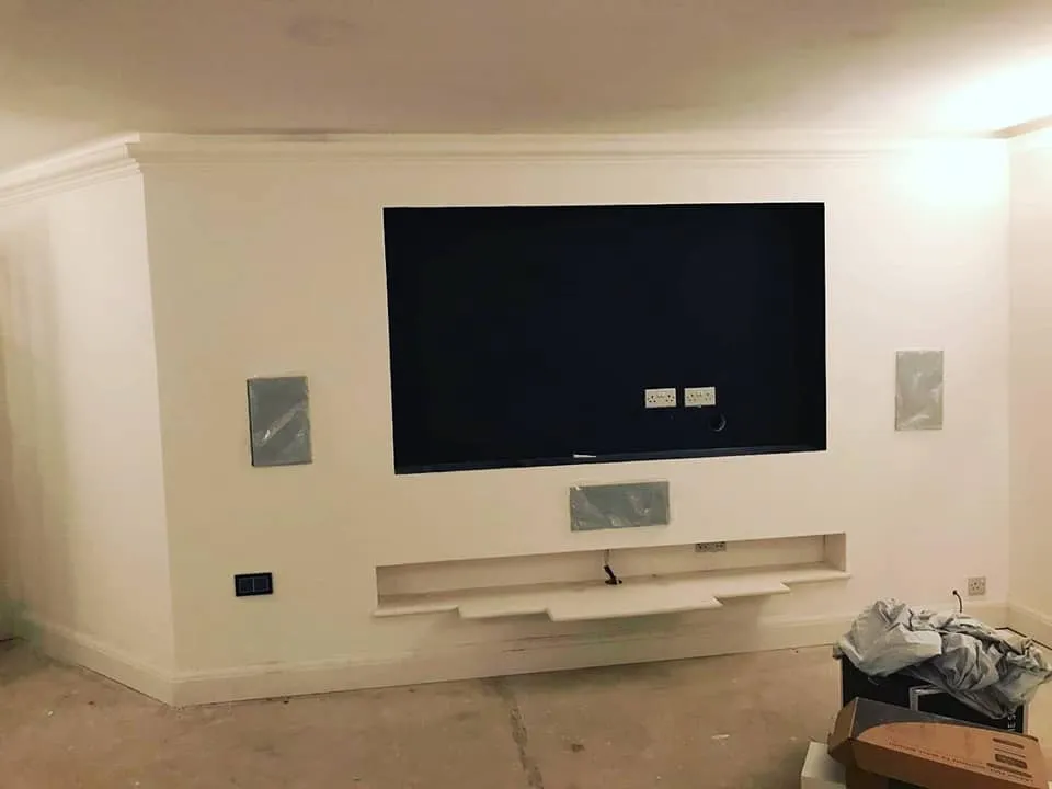A flat screen tv mounted on a wall in a living room.